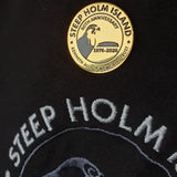 Gold badge with 'Steep Holm Island' text on a black background