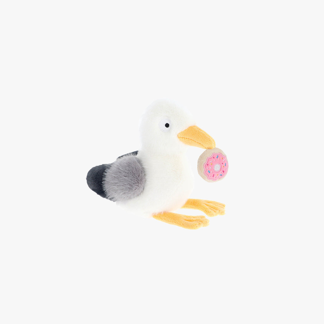 Plush toy seagull with a donut on a white background