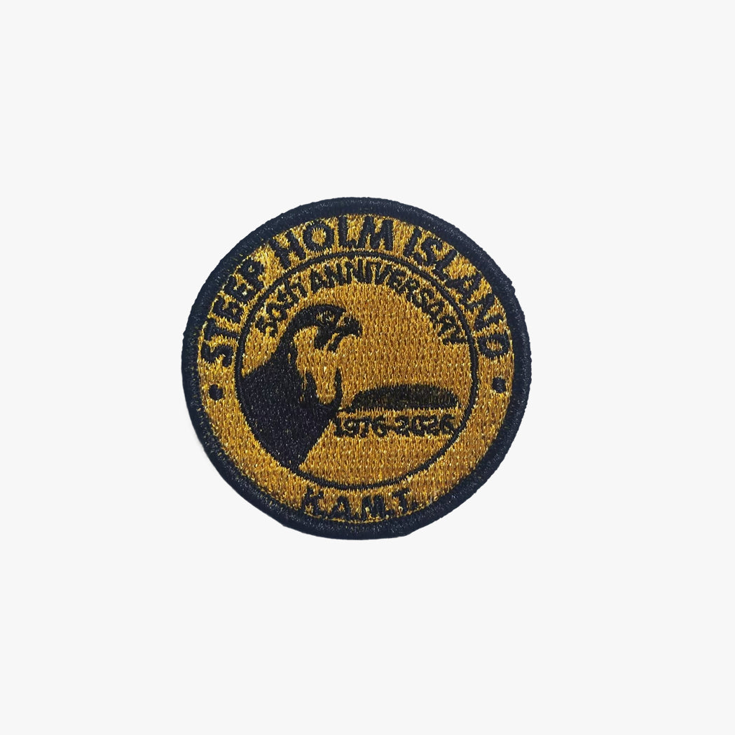 Round embroidered patch with text and a logo on a white background