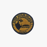 Round embroidered patch with text and a logo on a white background