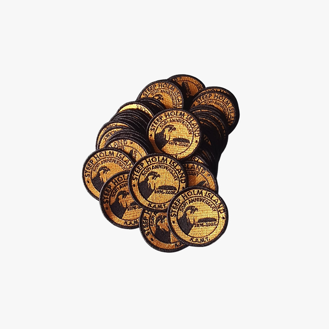 Collection of round embroidered patches with branding on a white background